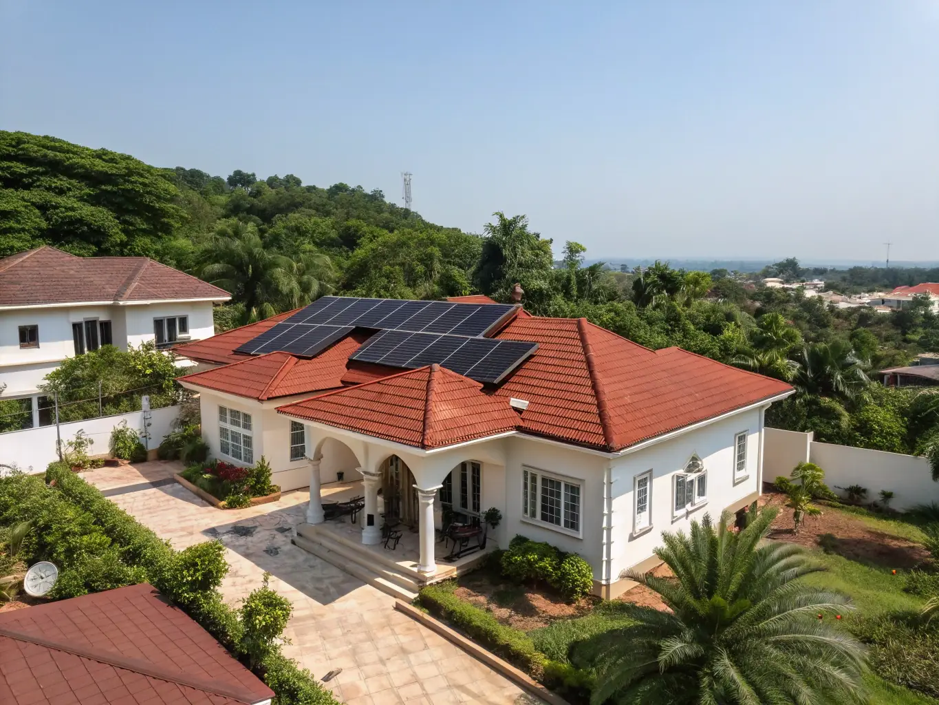 A modern residential house in a serene Nigerian neighborhood, showcasing a typical family home with a well-maintained garden and secure fencing.